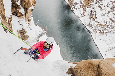 High angle view of woman ice climbing at Chipeta falls, Colorado