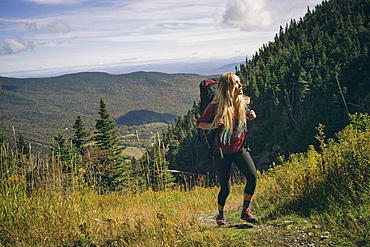 Female Hiker Hiking On Grassy Field In Mount Mansfield