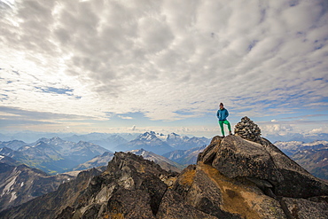 Long Exposure Of Female Climber On Top Of Mount Marriott