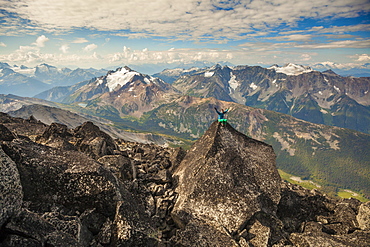 Long Exposure Of Female Climber Sitting On Top Of Mount Marriott