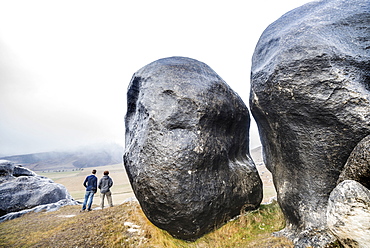 Two Men Exploring Castle Hill Near Arthur's Pass Outside Of Christchurch, New Zealand