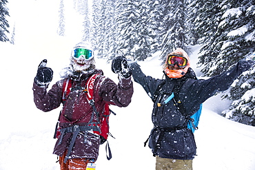 Two Happy Friends Enjoying In Snowy Region During Snow In Revelstoke, British Columbia, Canada