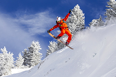 Person Snowboarding On Snowy Landscape In Chamonix Valley