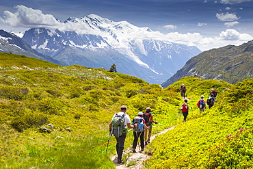 Group Of Hikers Hiking From Aiguillette Des Posettesinto The Chamonix Valley