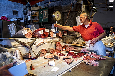 A Fishmonger Weighing Fish For A Customer In Sicily, Catania