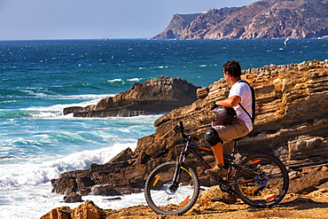 Cyclist Exploring Oceanic View In Sintra Cascais Natural Park