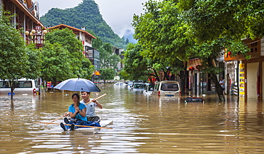 Couple Floating On A Raft During The Floods In Yangshuo