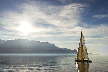 A Sailboat Gliding Over Lake Geneva On A Sunny Day