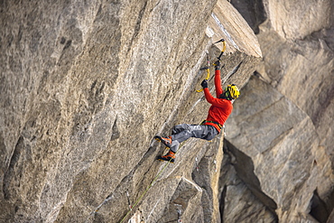 Male Climber Ice Climbing And Drytooling In Ceresole Reale Ice Park