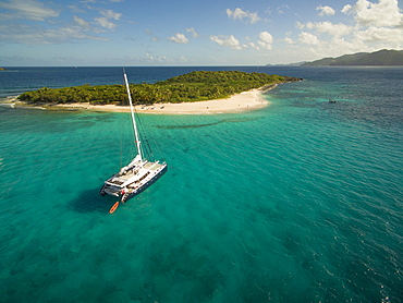 A Catamaran Rests In The Clear Waters Near Sandy Cay In The British Virgin Islands