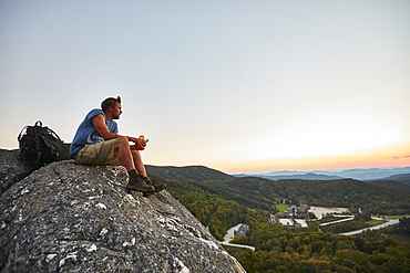 A Man Sits On A Rock Enjoying The Sunset Along The Appalachian Trail