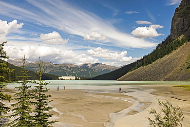 Lake Louise In Banff National Park On A Sunny Day Attracts Tourist Of All Ages