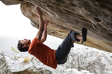 A Strong Male Boulders Without Ropes On An Overhanging Roof In Chimanimani National Park