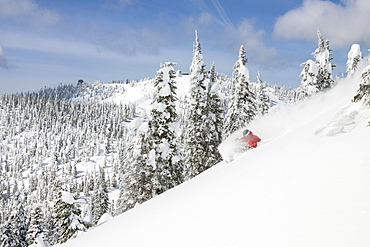 Male Skier Makes A Deep Powder Turn On Snowy Landscape In Whitefish, Montana, Usa