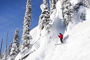 Male Skier Stops To Look Around While Skiing In North Bowl Chute In Whitefish, Montana