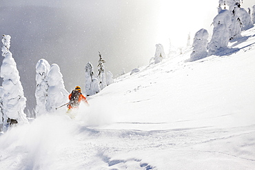 Male Skier Skiing On Deep Powder Turn In Whitefish Mountain Resort