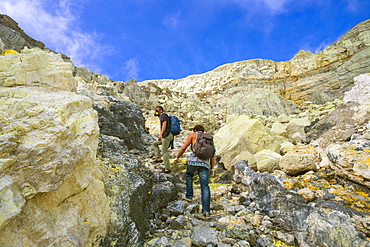 Two Men Hiking In Volcano Kawah Ijen, Java, Indonesia