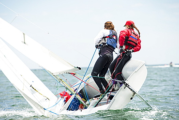 Two Teenage Girls Sailing Boat At Narragansett Bay As Part Of Junior Sailing Program