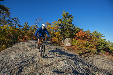 Mountain Biker Riding On The Bare Granite Slabs