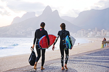 Female Surfers Walking On Arpoador Beach In Rio De Janeiro, Brazil