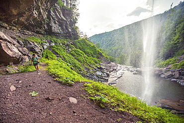 Hiker Walking Under The Kaaterskill Waterfalls, New York, Usa