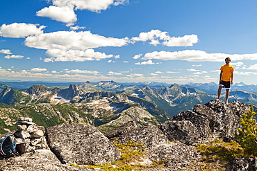 A Hiker Stands On The Summit Of Vicuna Peak, British Columbia, Canada