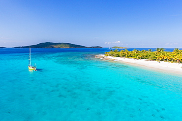 A Sailboat Moored Off An Uninhabited Islet Of The British Virgin Islands In The Caribbean