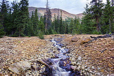 Mountain scene with a small stream running through rocks