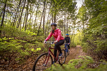 A Couple Mountain Biking On A Forest Trail Near Stonehouse Pond In Barrington, New Hampshire