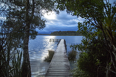 Wooden Dock On Lake During Sunset