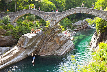 View Of a Diver Leaping From Ponte Dei Salti Bridge Over River At Valle Verzasca, Switzerland