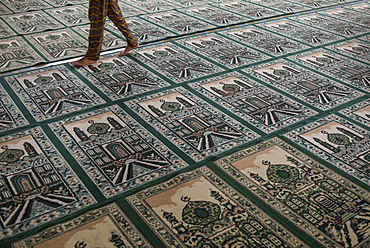 A Person Walking On Top Of Muslim Praying Carpet Inside The Grand Mosque, Medan, Sumatra, Indonesia