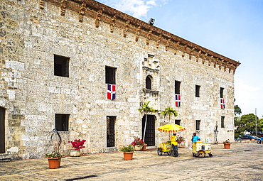 A Historic Stone Fort Building In A Plaza With A Few Colorful Vendors Selling Goods On A Sunny Day