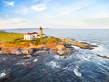 Aerial view of Beavertail Lighthouse in Jamestown, RI, during moonrise