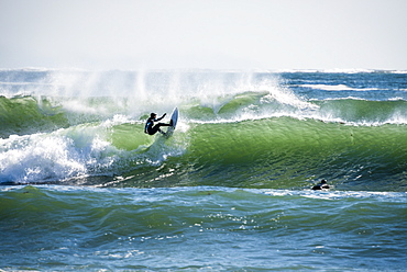 Man surfing large winter swell in Rhode Island