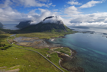 Highway E10 winds its way below Volandstind mountain peak, Flakstadøy, Lofoten Islands, Norway