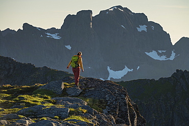 Female hiker on summit of Veinestind, Moskenesøy, Lofoten Islands, Norway