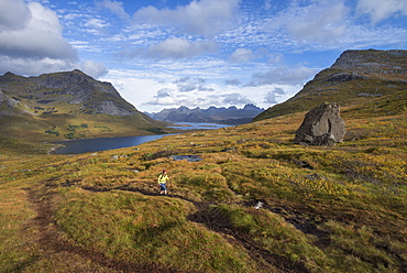 Female hiker hiking trail above Selfjord, Lofoten Islands, Norway