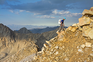 A man negotiating the ridgeline along the Evolution Traverse, John Muir Wilderness, Kings Canyon National Park, Bishop, California.