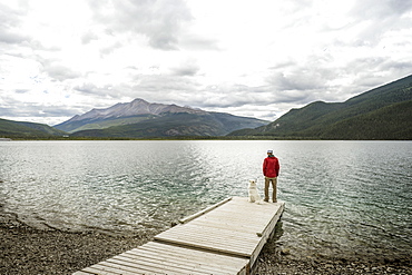 Muncho Lake British Columbia man and dog on dock