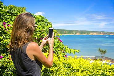 Female tourist taking picture with smart phone