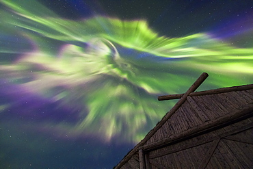 The Northern Lights over a boathouse at Norstead Viking replica village in Newfoundland.