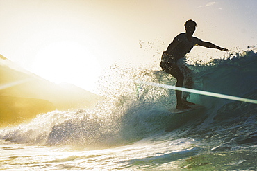 Young surfer having fun in a morning surf session