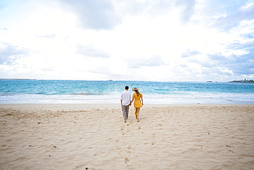 Engaged couple portrait on the beach at North Shore Oahu Hawaii in the Spring.