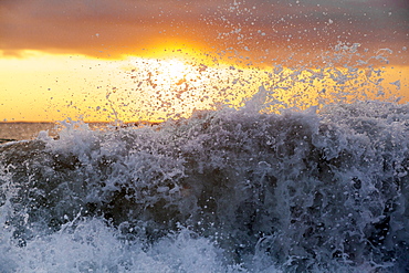 A foam wave seperating into a million droplets.