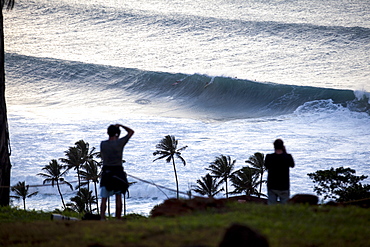 Spectators watching big surf at Waimea Bay, on the north shore of Oahu.