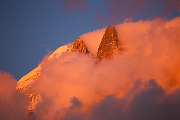 Pink evening light (Alpenglow) on the famous Drus mountain, as seen from Chamonix.