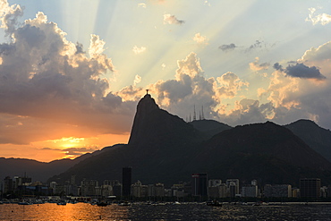 Sunset behind Morro do Corcovado and Cristo Redentor seen from Urca, Rio de Janeiro, Brazil