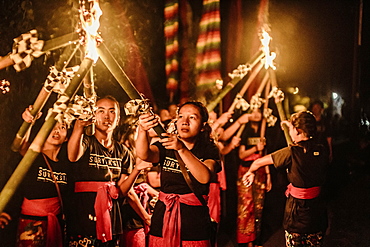 People holding torches with fire in preparation for celebration event, Tabanan, Bali, Indonesia