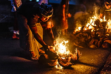 Person burning coconut husks at night, Tabanan, Bali, Indonesia